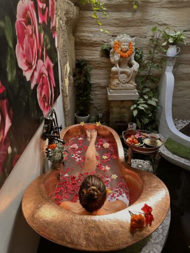 Luxury flower bath with tropical rose and frangipani petals floating in private pool at 11:11 Bali Retreats Ubud