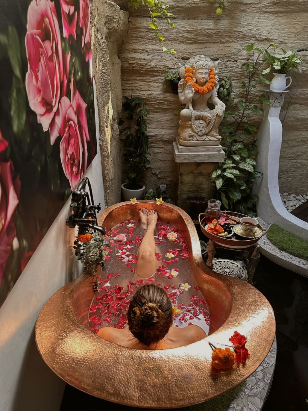 Luxury flower bath with tropical rose and frangipani petals floating in private pool at 11:11 Bali Retreats Ubud