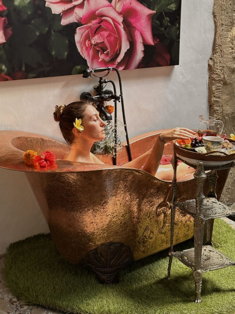 Copper bathtub filled with tropical flowers at 11:11 Bali Retreats luxury retreat Ubud